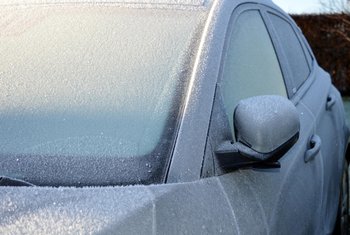 Windshield covered in snow ice